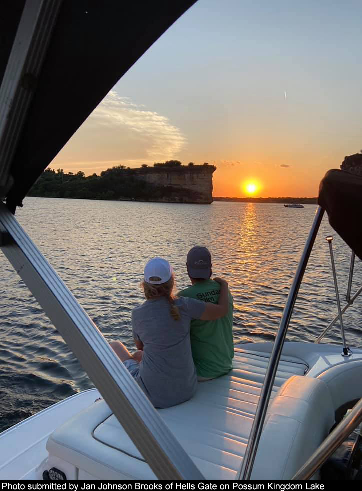 Two people watching the sunset on Possum Kingdom Lake