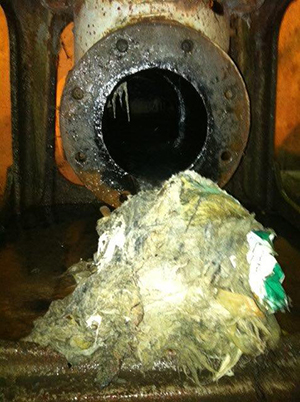 A fatberg next to a pipe