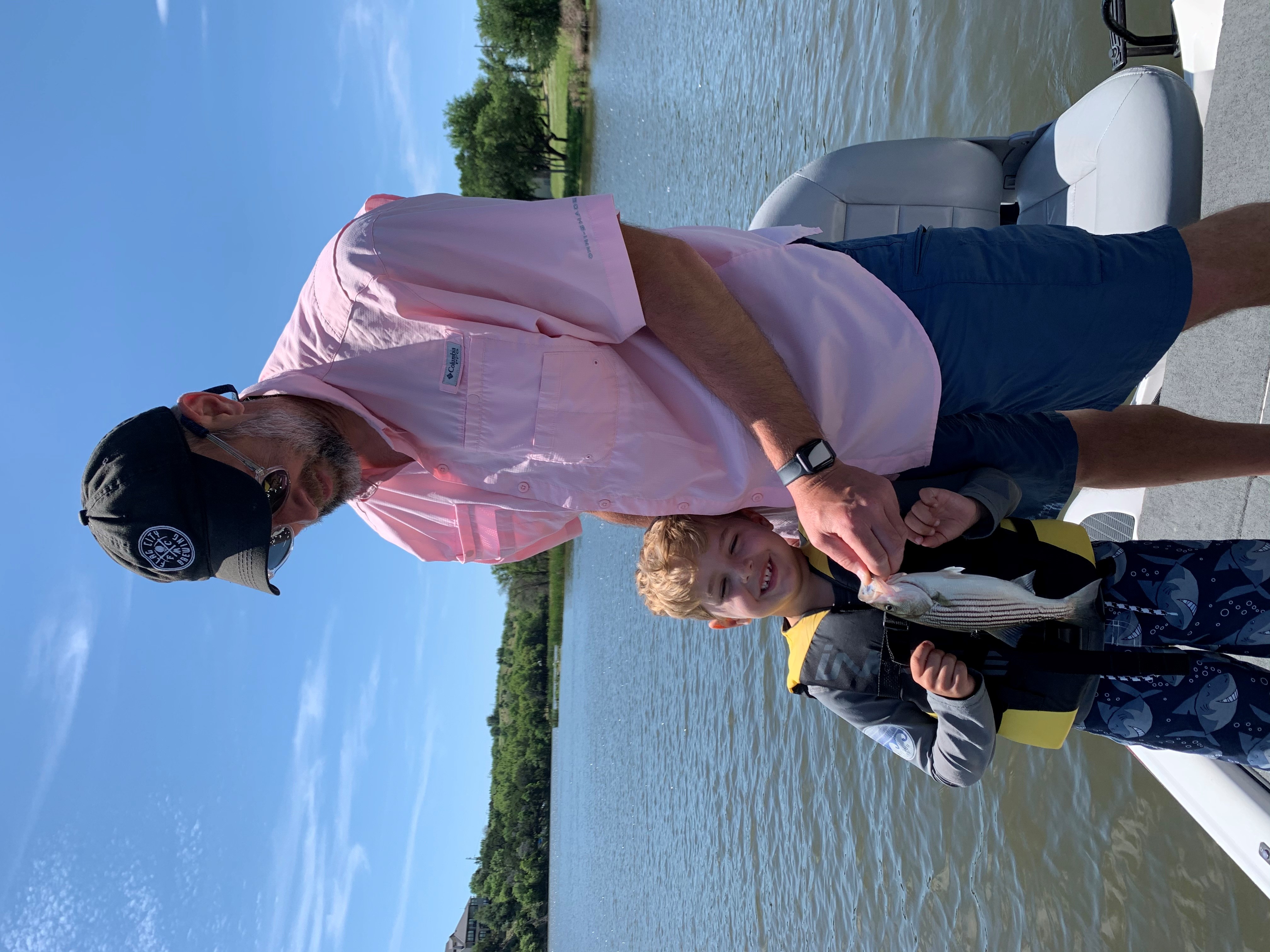 A man and child holding a fish at Possum Kingdom Lake