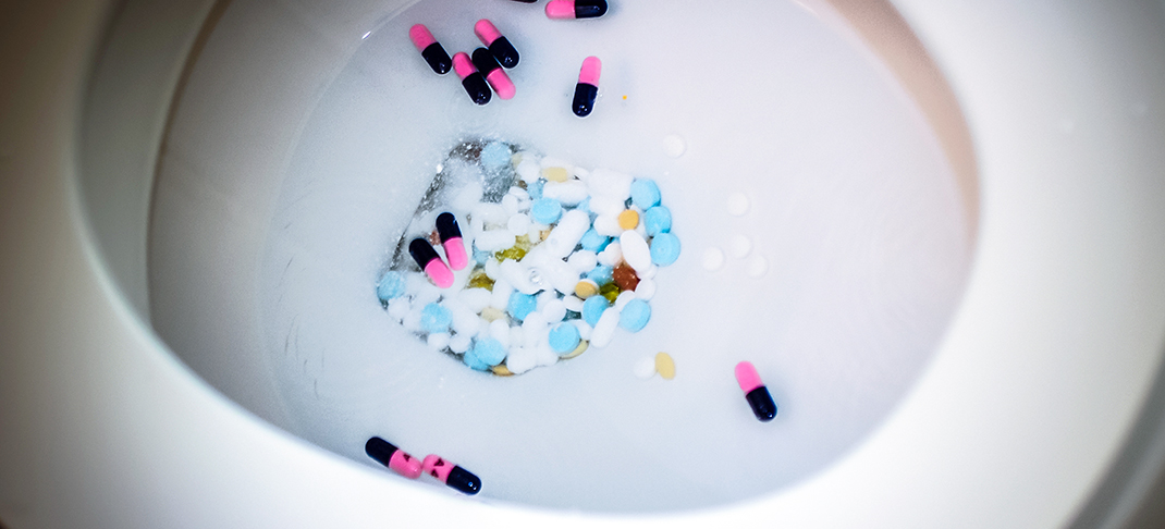 Pills being flushed down the toilet
