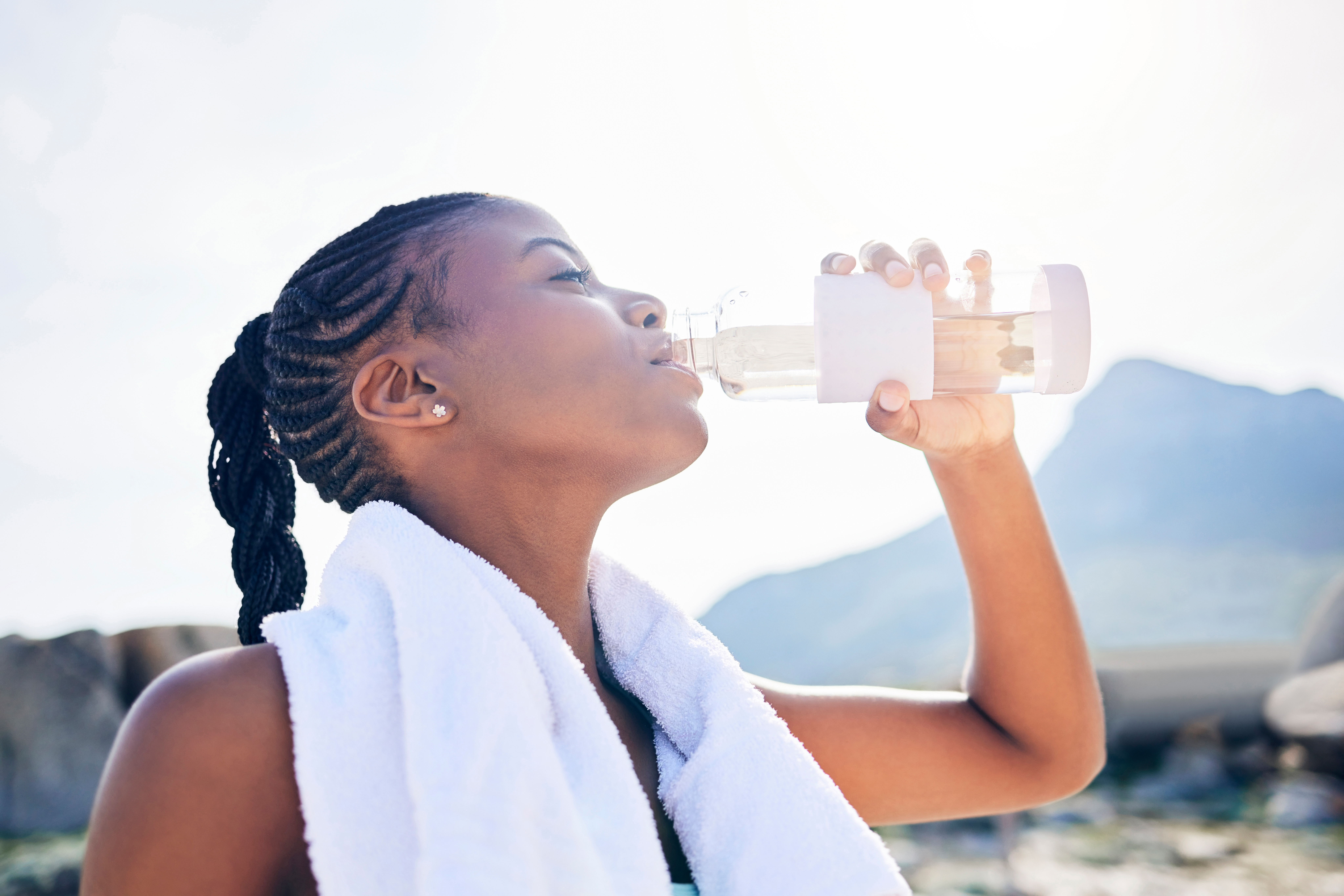 A woman drinking water on a hot day