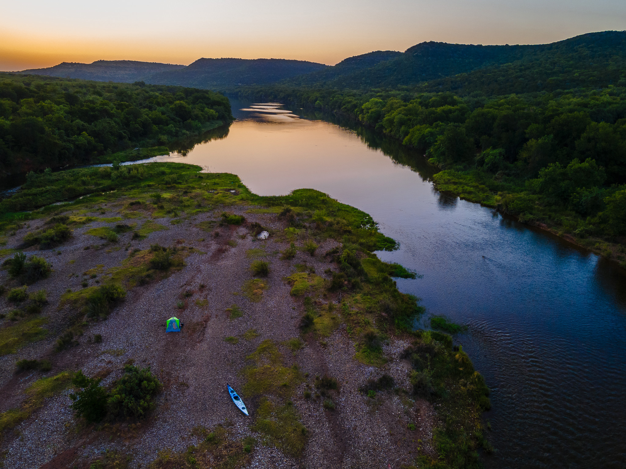 An aerial view of the Brazos River at sunset