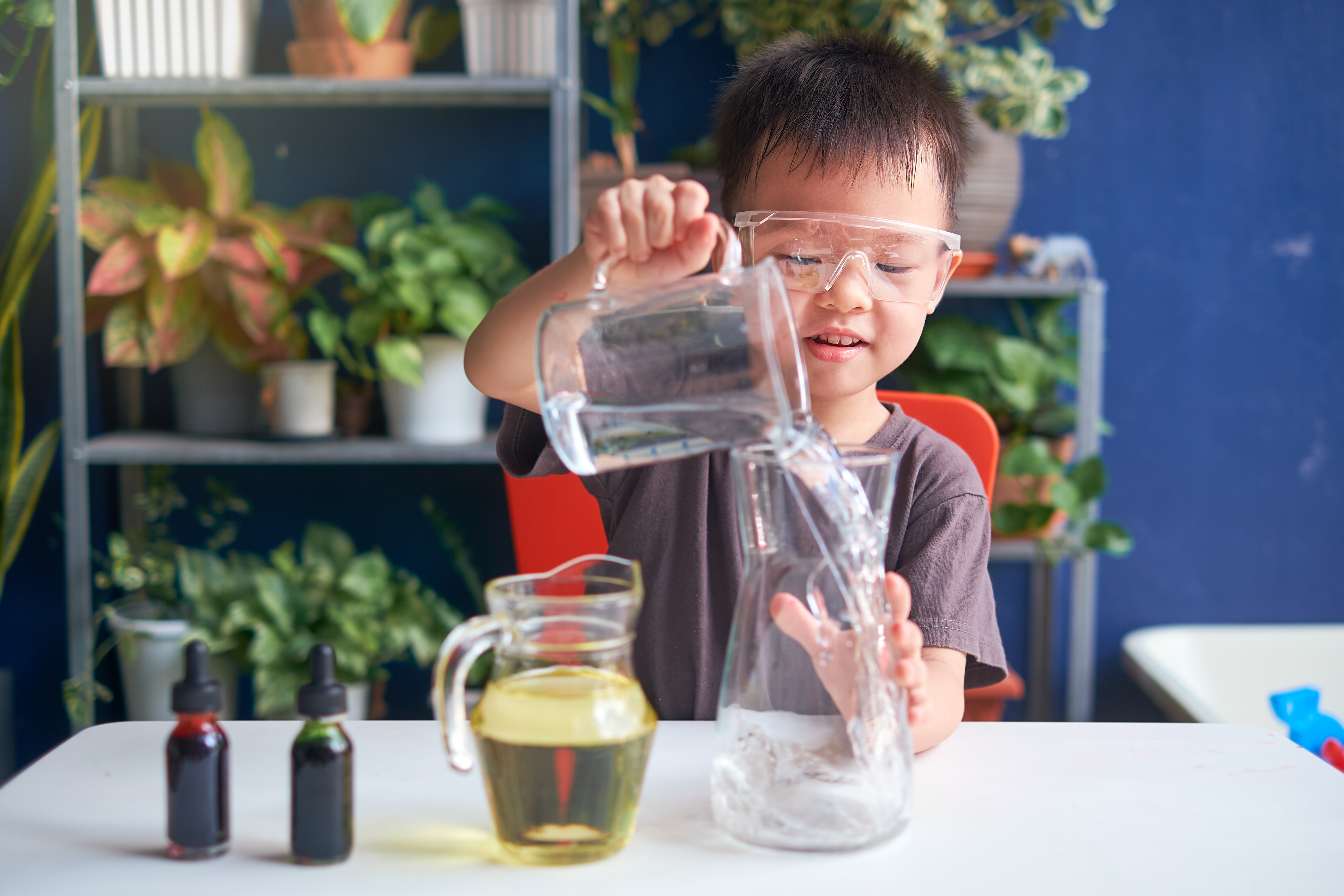 A kid doing a science experiment with water